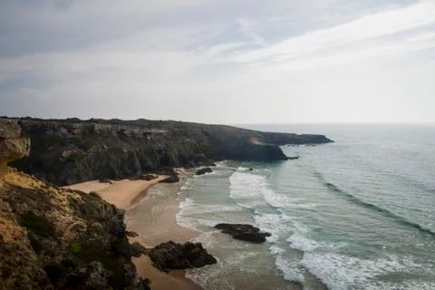 Beach with waves and cliffs Stockfoto's