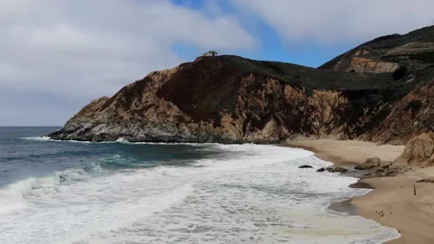 Beach with Waves and House in Slow Motion with Aerial Tilt Up Stock Footage 142310205