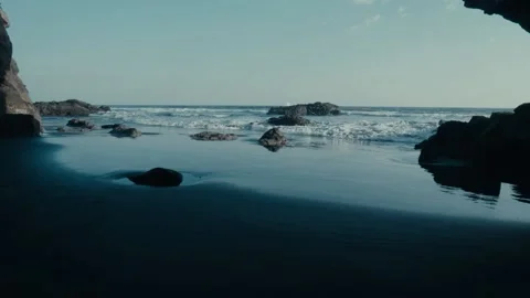 Beach waves and rocks, black sand, slow motion Stock Footage 134438029