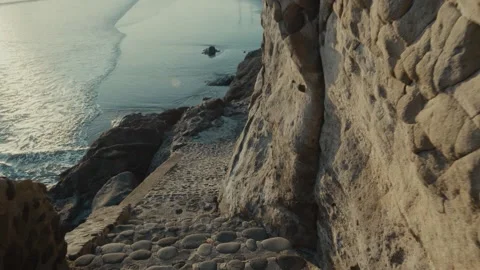 Beach waves and rocks, black sand, slow motion Stock Footage 134438278