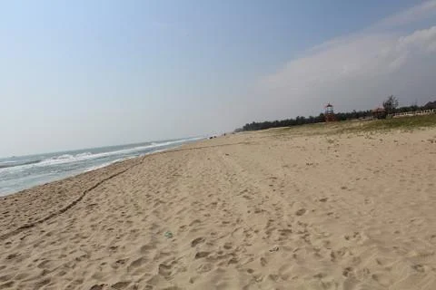Beach waves and sand with blue sky Stock Photos