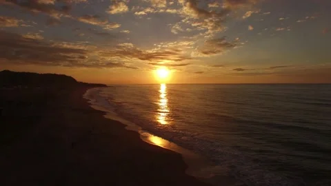 BEACH WAVES AND SUNSET AERIAL SHOT Stock Footage 130865675