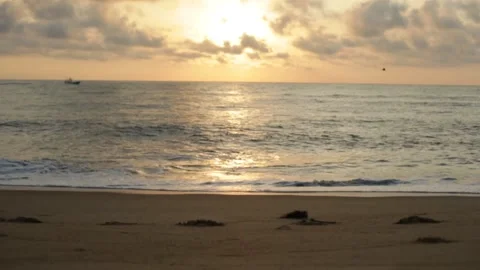 Beach Waves with a Boat Passing at Sunset Stock Footage 227066766