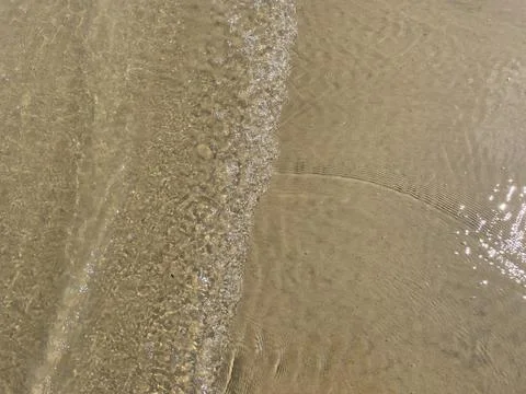 Beach waves with clear water. small wave ripples Stock Photos