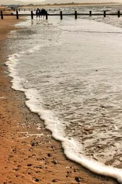 Beach waves with couple Stock Photos