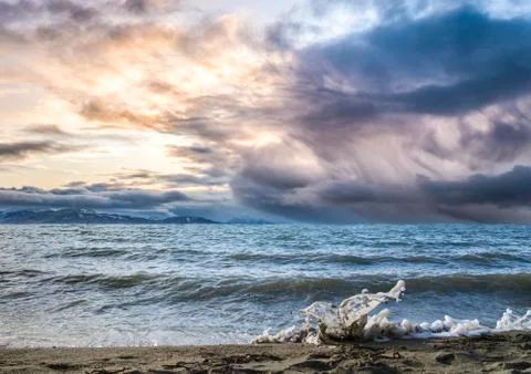 Beach waves with dramatic sunset sky Stock Photos