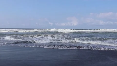 Beach waves with foam during the day on a blue sky background. Stock Footage 162295633