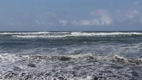 Beach waves with foam during the day on a blue sky background. Stock Footage 162295763