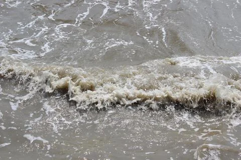 Beach waves at the harbor during the day Stock Photos
