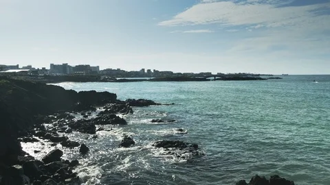The beach with the waves hitting the sea and the horizon.Jeju Island, South Kore Stock Footage 117694167