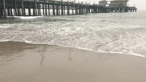 Beach waves near a pier Stock Footage 139322673