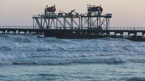 Beach waves with oil platform in ocean. Caspian sea offshore oil rig drilling pl Video stock 62020444