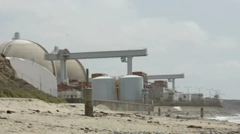 Beach waves pan and zoom to nuclear powerplant Vídeo Stock 39221933