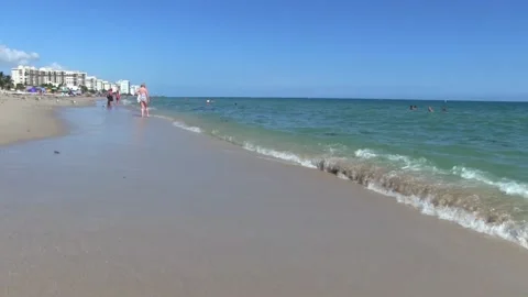 Beach Waves with people in the back Stock Footage 142382854
