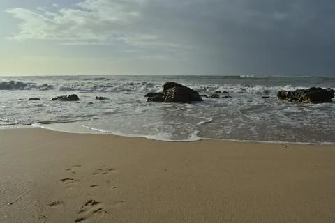 Beach Waves Rocks Footprints Stock Photos