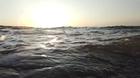 Beach waves splashing on rocks being shot up close at slow motion Stock Footage 142458543