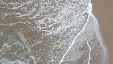 Beach Waves splashing on seashore under the sun heat Stock Footage 136877644