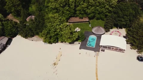 Beach wedding ceremony by the pool and wedding arch on the beach. Aerial view Video stock 322051261