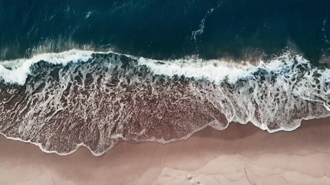 Beach with white sand and the blue sea. Aerial top down view. Video stock 231057985