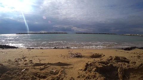 By the beach in winter with a man running out of the water Stock Footage 182275682