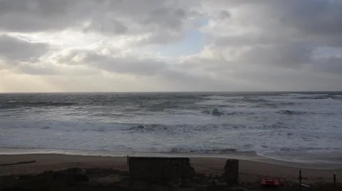 Beach in winter with nobody, waves and cloudy sky in normal speed Video stock 48131123