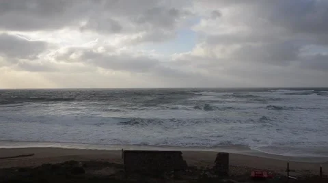 Beach in winter with nobody, waves and cloudy sky in slow speed Video stock 48131171