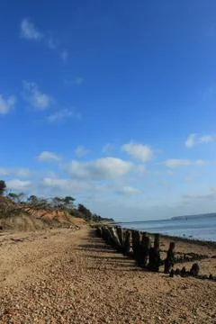 Beach with wooden posts Stock Photos