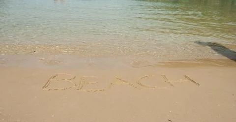 Beach word in the sand at the beach Stock Photos