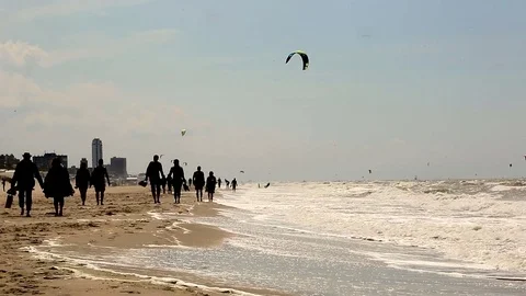 Beach in Zandvoort, Netherlands. Group people walking together along beach Stock Footage