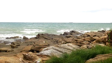 Beaches and waves are shifting to the shore. Rocks by the sea Stock Footage 77804848