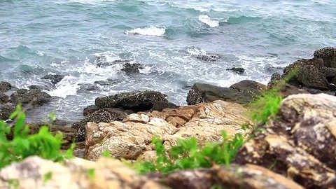 Beaches and waves are shifting to the shore. Rocks by the sea Stock Footage 77804873