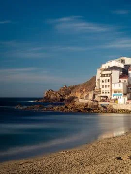 Beaches with waves and cliff at sunset on the Spanish coast Stock Photos