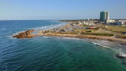 Beachfront and rocks at Pollock Beach revealed in aerial slider movement Stock Footage 126125145