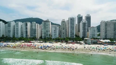 Beachfront cityscape view, tropical beach paradise, urban beach scene Stock Footage 309277387