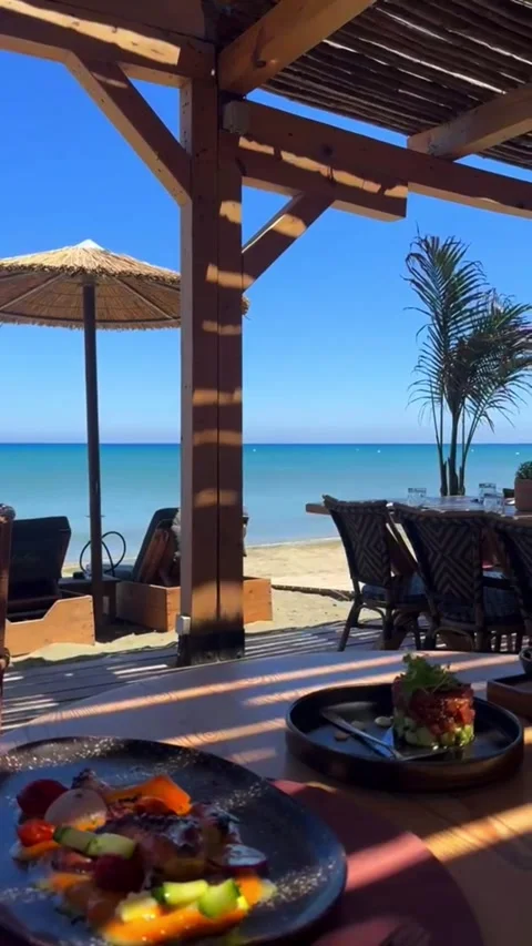 Beachfront Restaurant Dining Area with Food - Vertical 4K 스톡 동영상 336340177