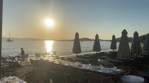 Beachfront Restaurant At Sunset On Agia Anna Beach Naxos Greece - July 1, 2026 Stock Footage 339668487