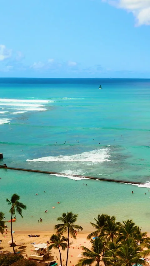 Beachfront tower with jetty and turquoise ocean. Vertical video. Stock Footage 319760849