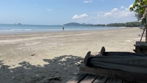 Beachfront view sandy beach sunny day. Blue sky landscape male walking. Thailand Video stock 225122886