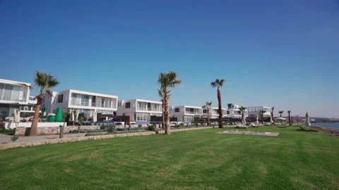 Beachfront villas line pristine coast, offering real estate investment in Stock Footage 268620817