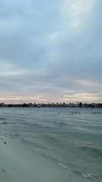 Beachfront Waves at Sunset with Distant Shoreline Stock Photos