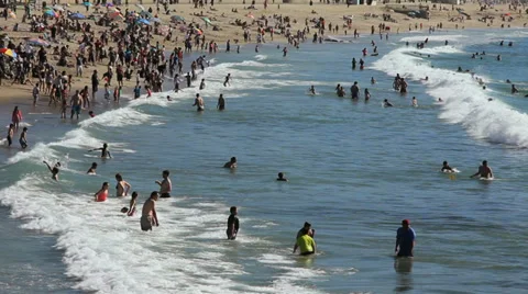 BEACHGOERS PLAY IN SURF Stock Footage 38426122
