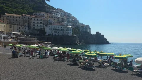 Beachgoers relaxing on Amalfi Beach Stock Footage 345370728