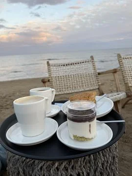 Beachside breakfast scene with coffee cups, parfait, and toast, perfect for.. 库存照片