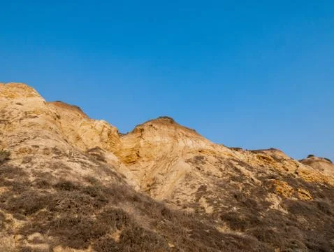 Beachside Cliff with Blue Sky Stock Photos