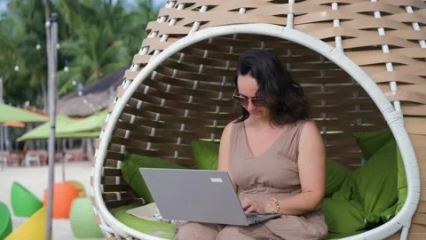 Beachside freelance work for female digital nomad 動画素材 312380590
