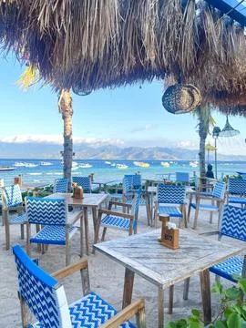 Beachside Restaurant Seating With Ocean View and Tropical Atmosphere Stock Photos