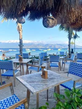 Beachside Restaurant Seating With Ocean View and Tropical Atmosphere Stock Photos