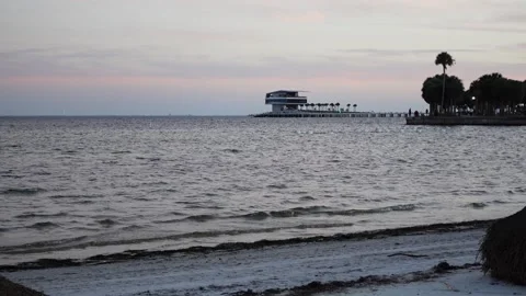 Beachside still with ambient waves in the sunset with St. Pete Pier Stock-Footage 168184394