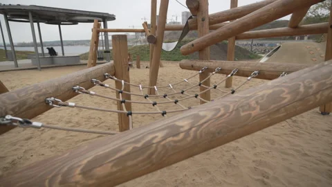 Beachside workout area features sturdy climbing net Stock Footage 306456819