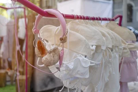 Beachwear in covers displayed with decorative shell headsets. Symbol of sea Stock Photos